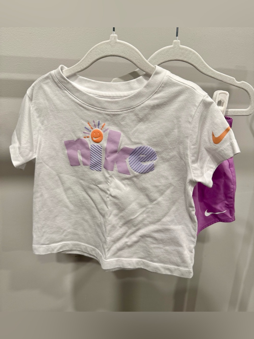 Nike White Tee with Lavender Logo and Orange Sun Accent